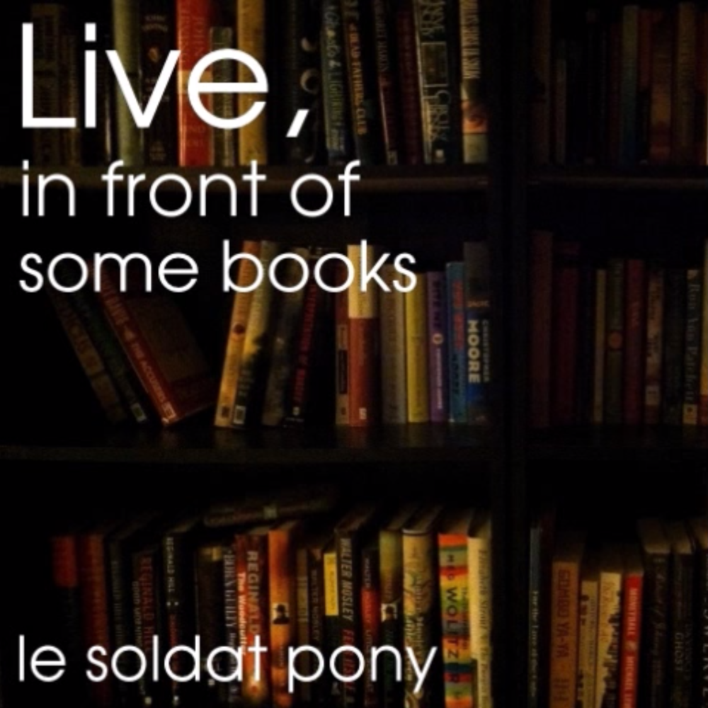 Live, In Front of Some Books